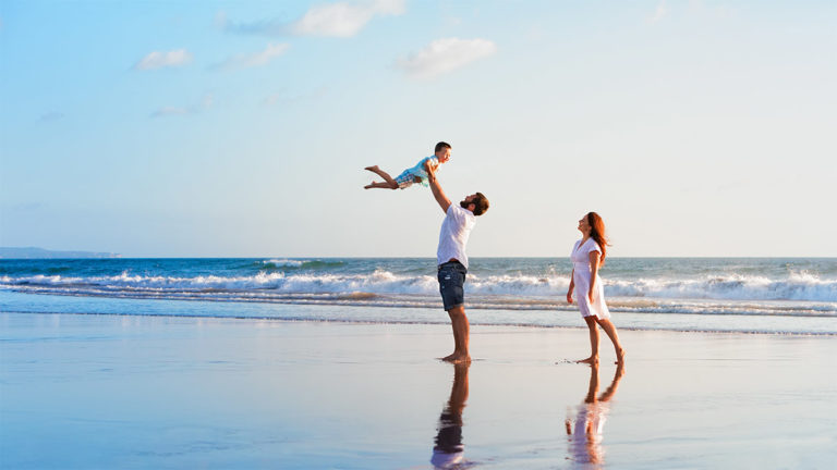 Wealth Management - Family playing on the beach