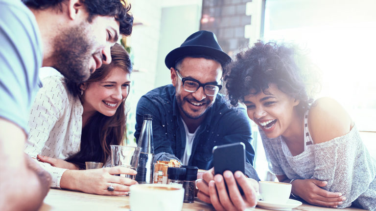 Temenos Infinity - Happy people looking at a phone