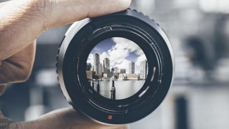 Buildings in the horizon seen through a lense representing Temenos Corporate product