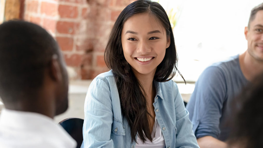 woman smiling while talking