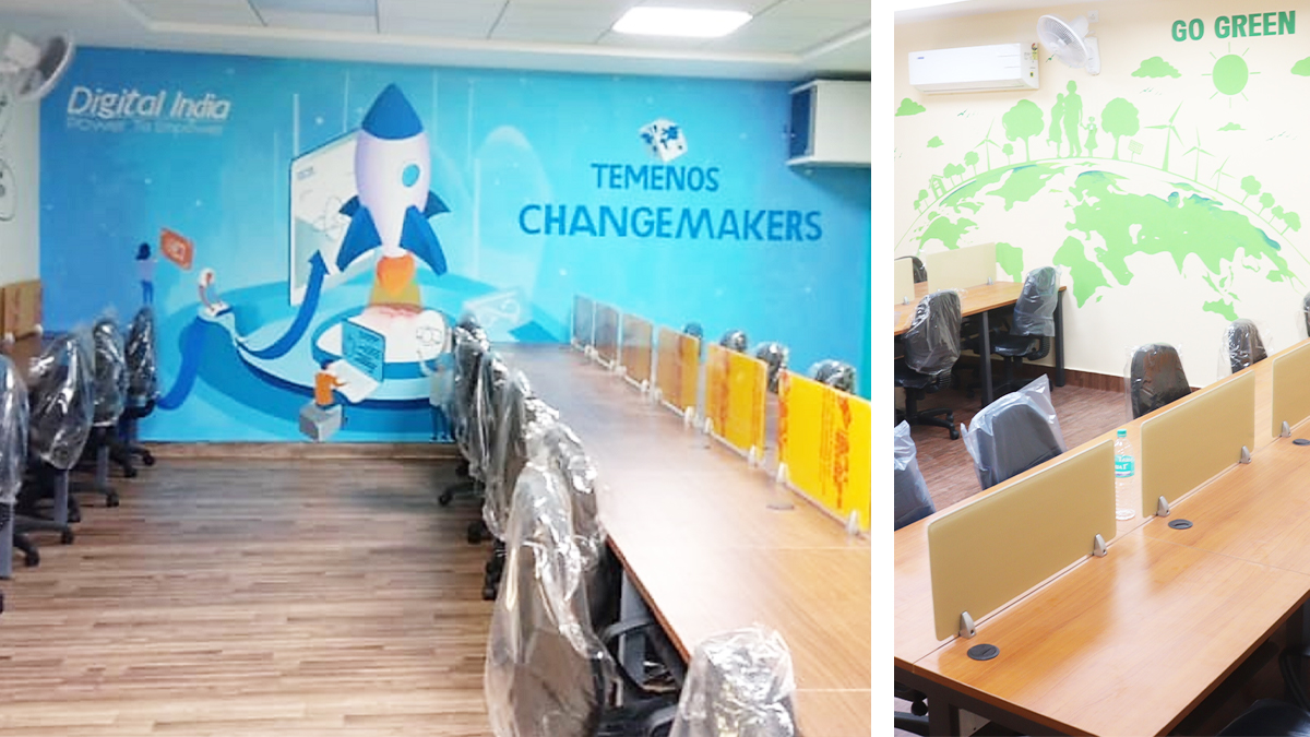 Modern office with long desks and swivel chairs covered in plastic. Blue wall features a rocket and "TEMENOS CHANGEMAKERS" text. Adjacent room has a "GO GREEN" theme with a green world map mural.