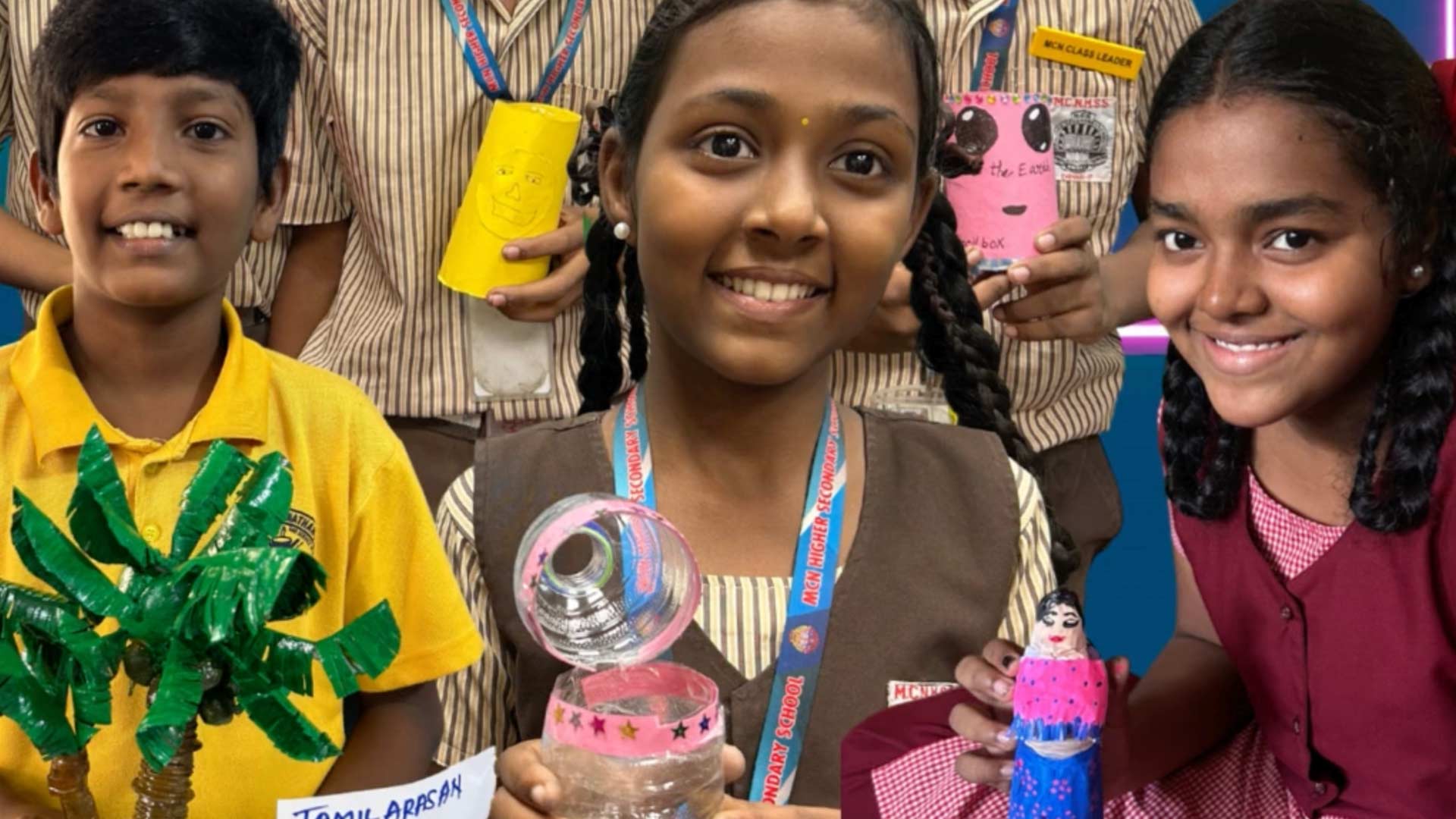 Three smiling children proudly display their colorful recycled crafts in school uniforms. The mood is joyful and creative, highlighting their projects.