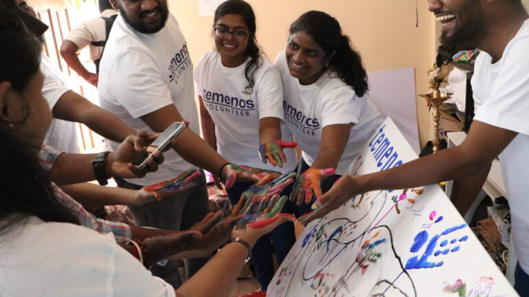 Temenos employees having a group high five