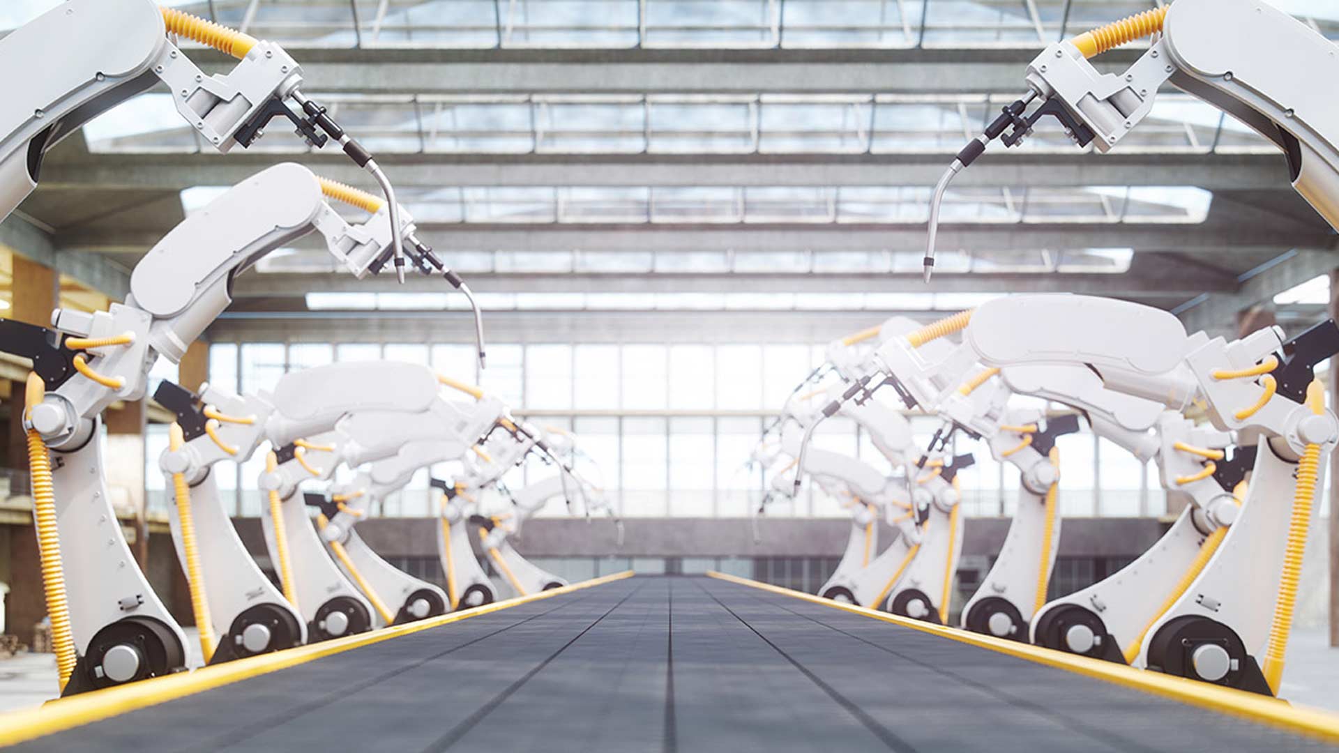Industrial robotic arms line both sides of a conveyor belt in a spacious, well-lit factory. The setting is orderly and futuristic, suggesting automation.