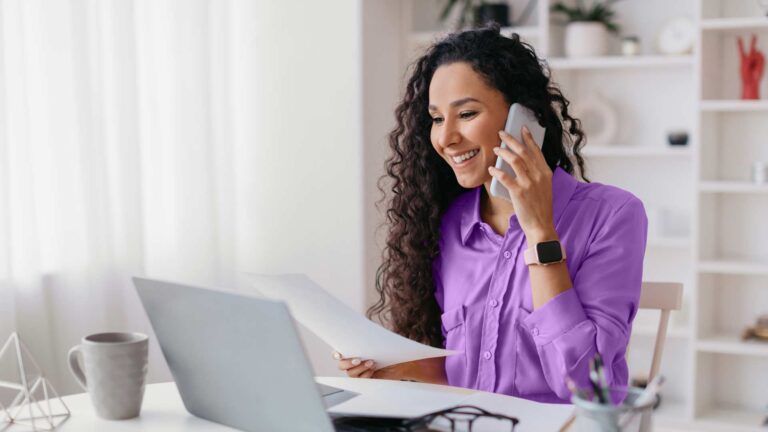 Woman on phone and working on computer