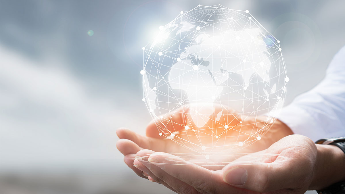Hands holding a translucent, network-connected globe, symbolizing global connectivity. The bright background conveys a sense of innovation and technology.