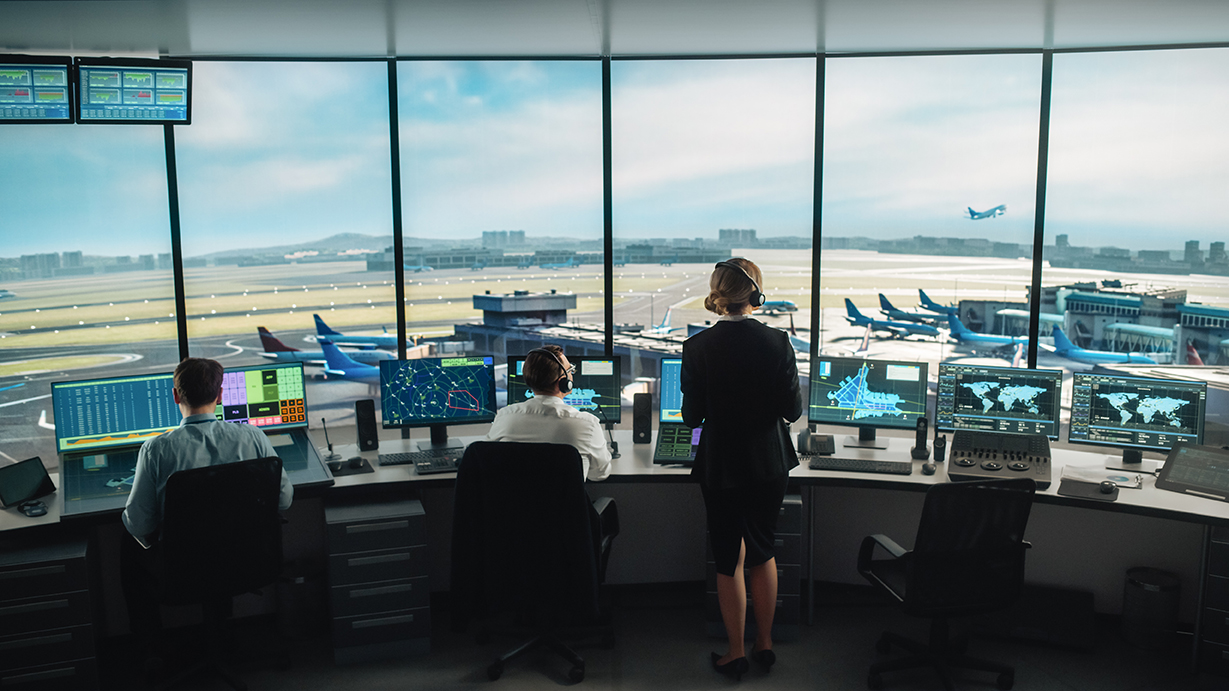 Businessman sitting in an airport seating area signifying real-time need for data and flight status