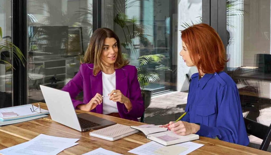 Hand over AI screen working on computer