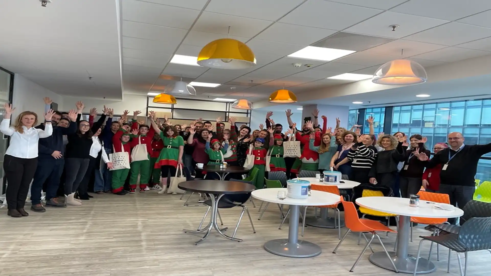 A group of people at an awards event, holding trophies and smiling. The backdrop displays "Great Place to Work" and logos, creating a celebratory and professional atmosphere.