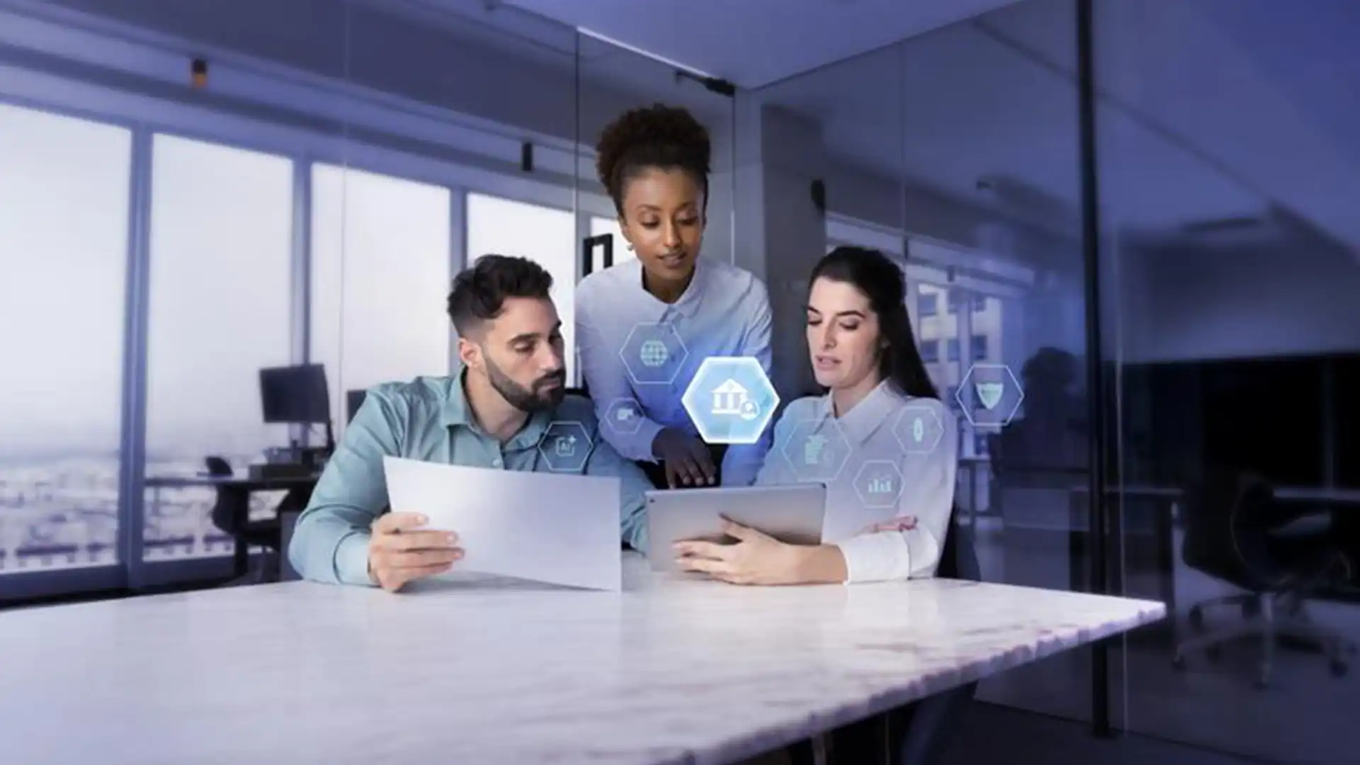 Coworkers sitting at table looking at laptop